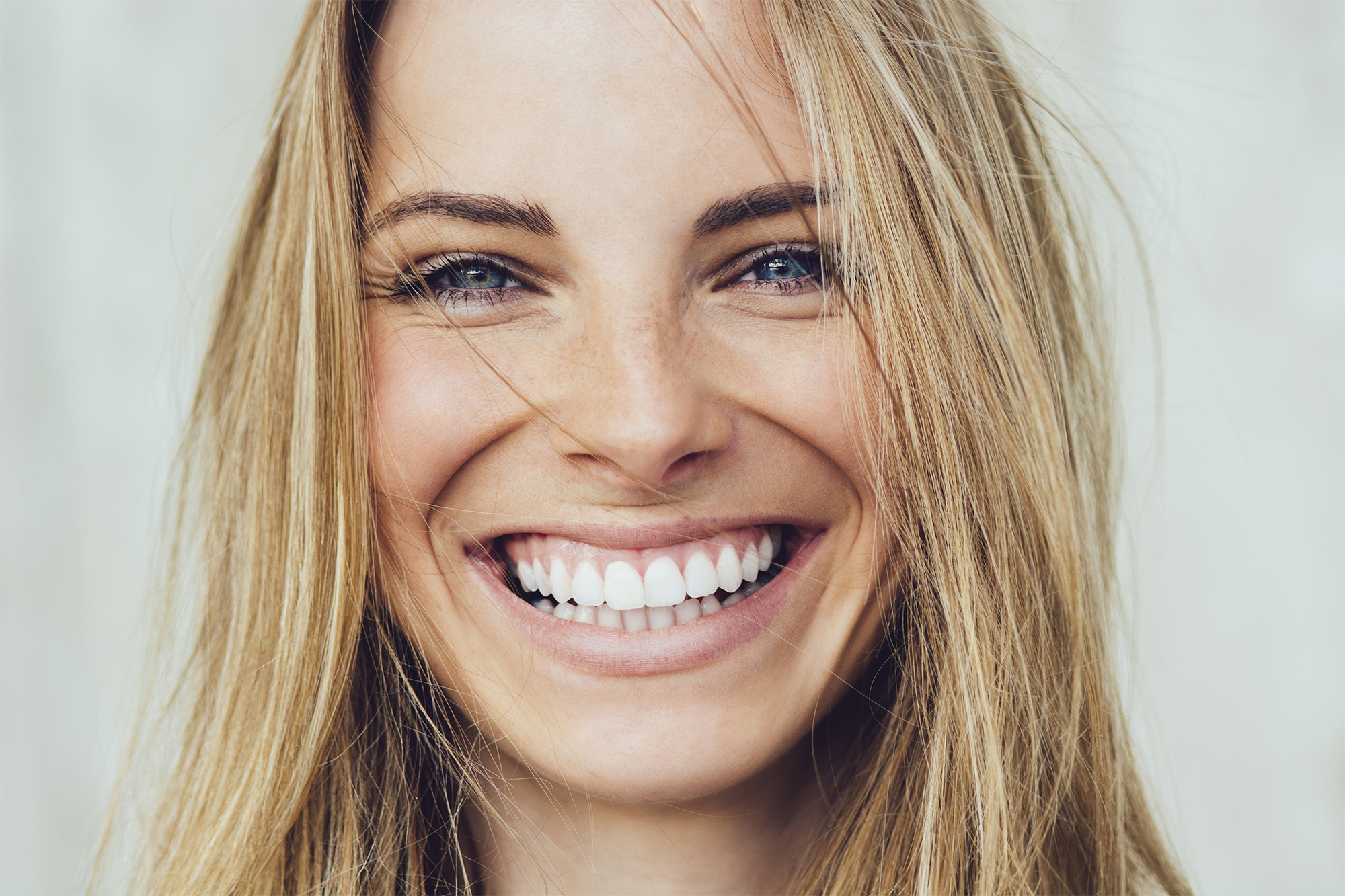 SMILING-BLONDE-GIRL-iStock-882495390.png