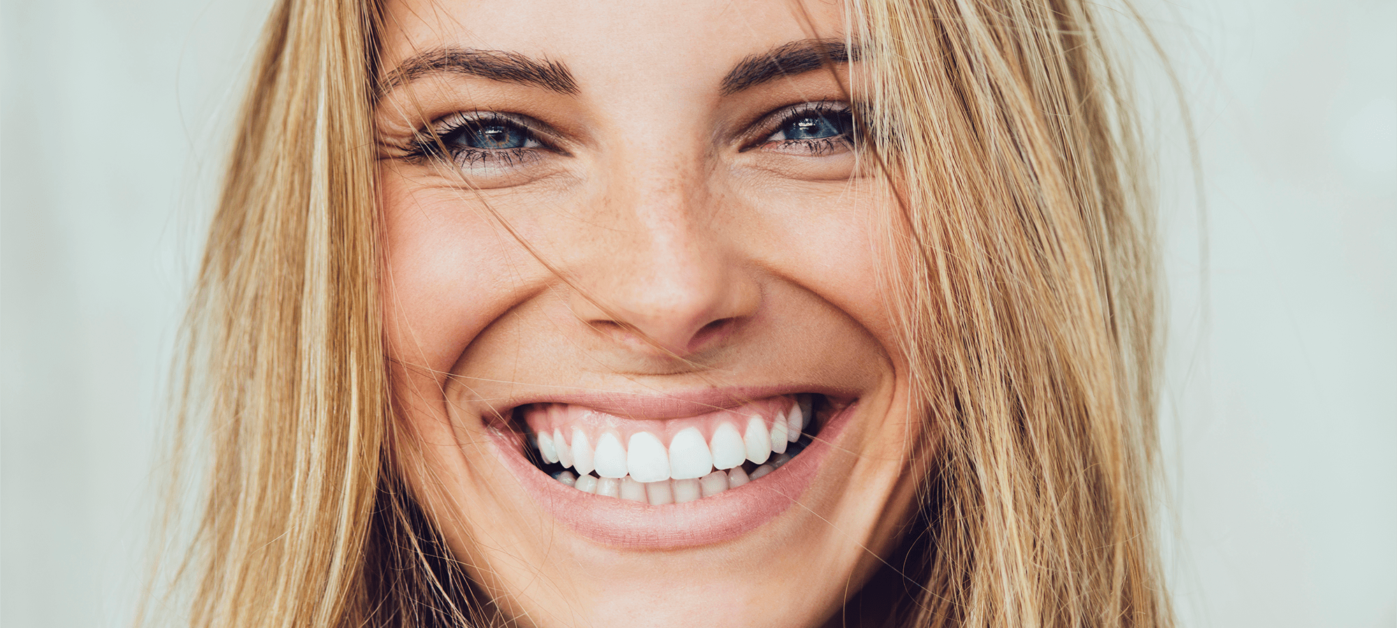 SMILING-BLONDE-GIRL-iStock-882495390.png